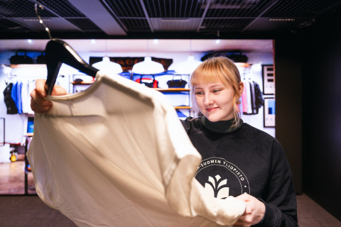 Person examining a T-shirt in Senselab.